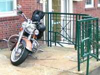 a wide-angle view of a motorcycle in front of a building
