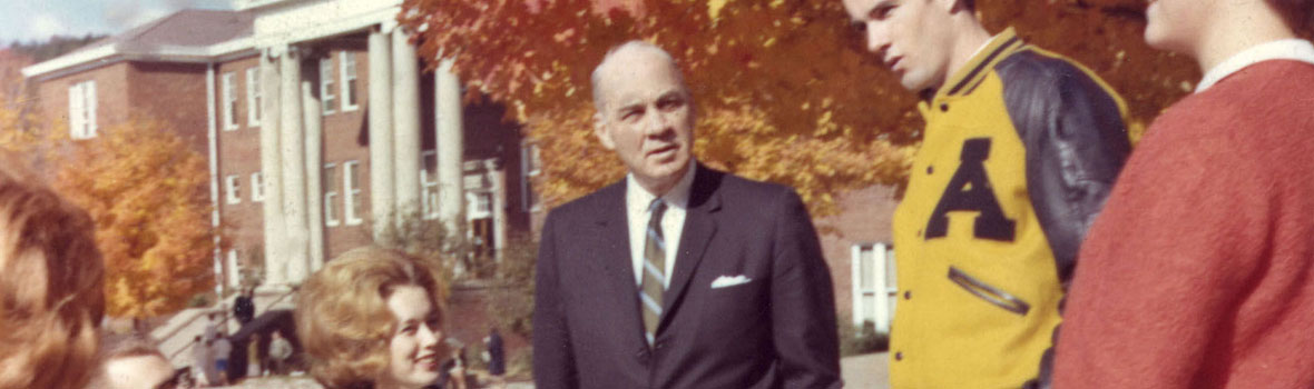 Appalachian State Teachers College (1929-1967) President William Howard Plemmons (1955-1969) speaking with students in front of the second Administration Building, built 1924.