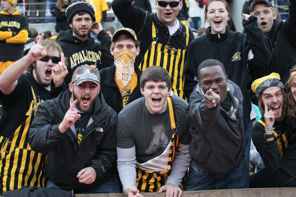 students cheering at football game
