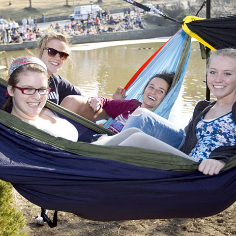 students in hammocks by the duck pond