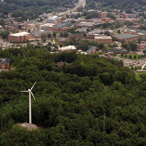 Turbine on hill overlooking campus