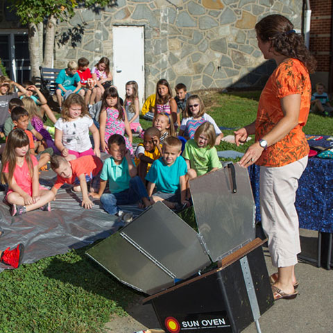 children viewing solar oven