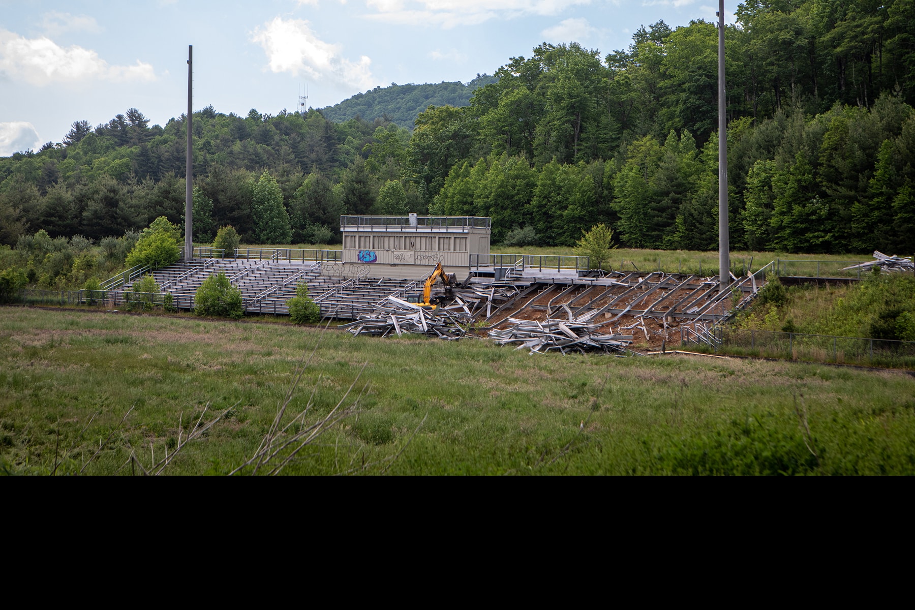 The grandstand at the old Watauga High School is dismantled as part of the App 105 project