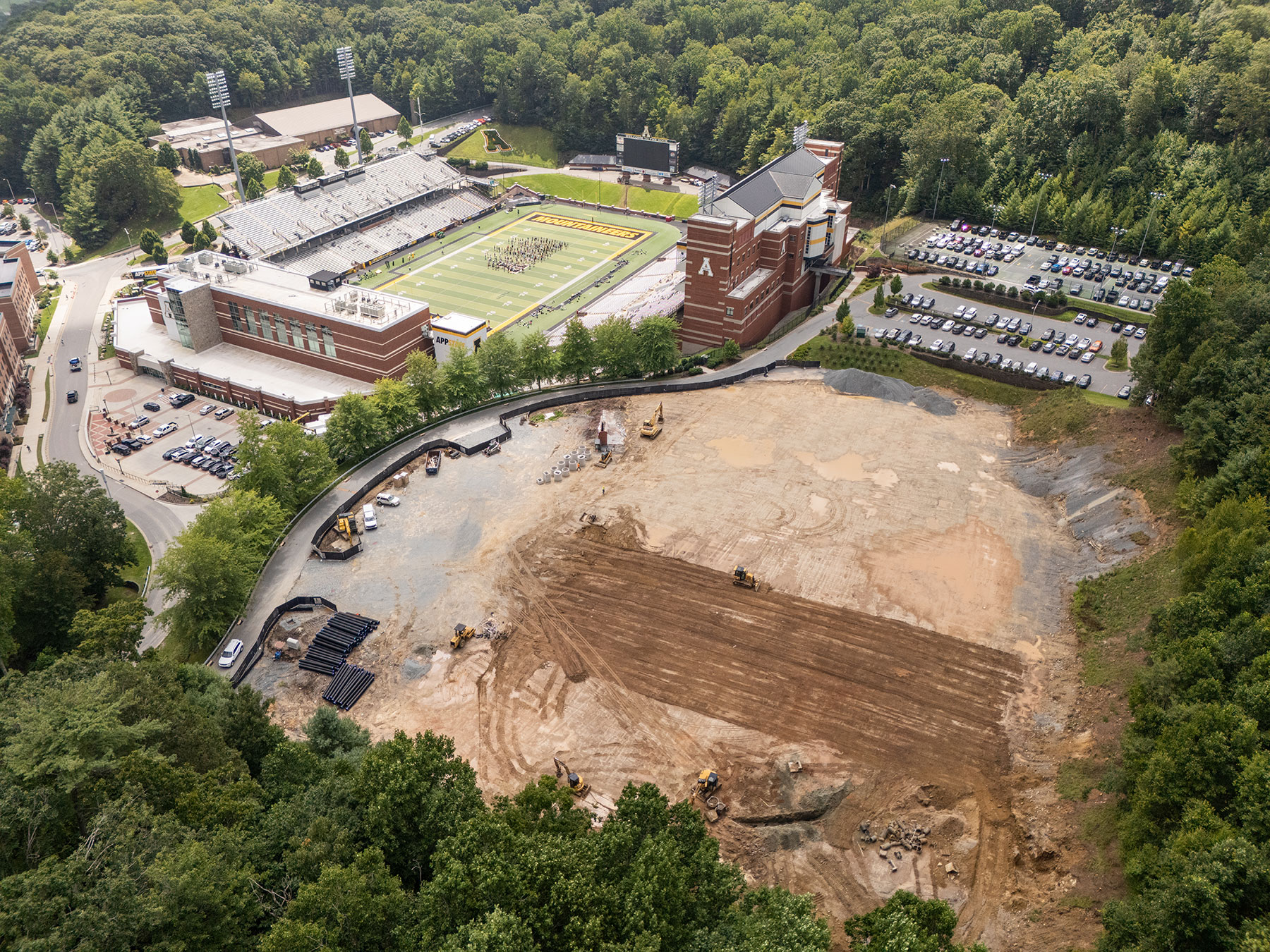 Aerial view of App State indoor facility site prep for utilities and retaining wall work.