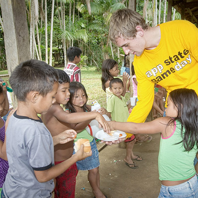 student feeding children