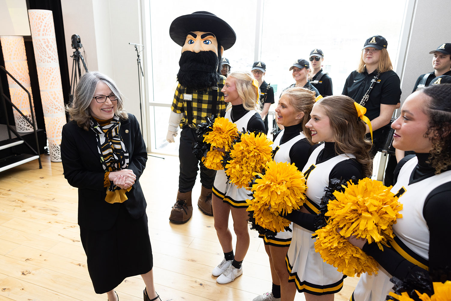 Chancellor Norris with Yosef and App State cheerleaders.