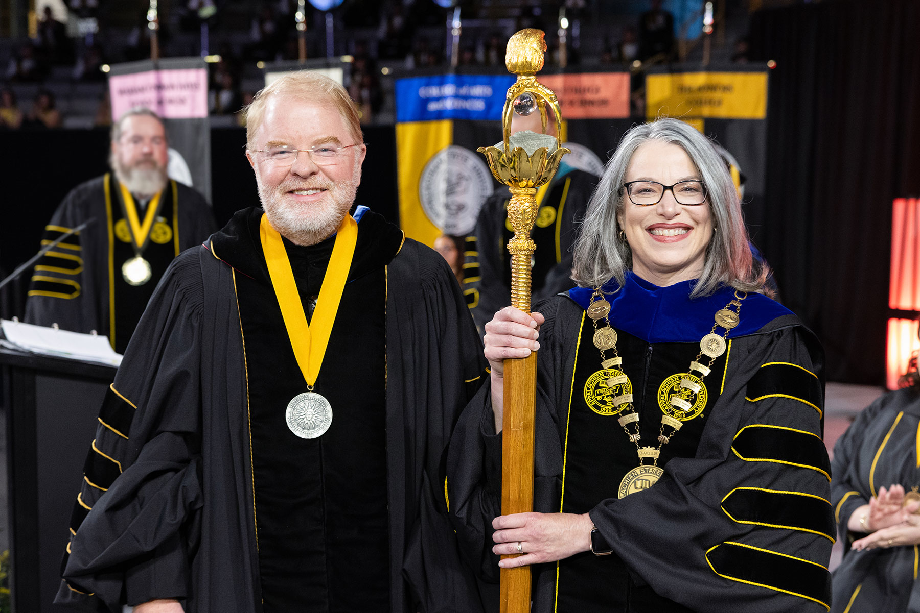 President Hans and Chancellor Norris holding mace.