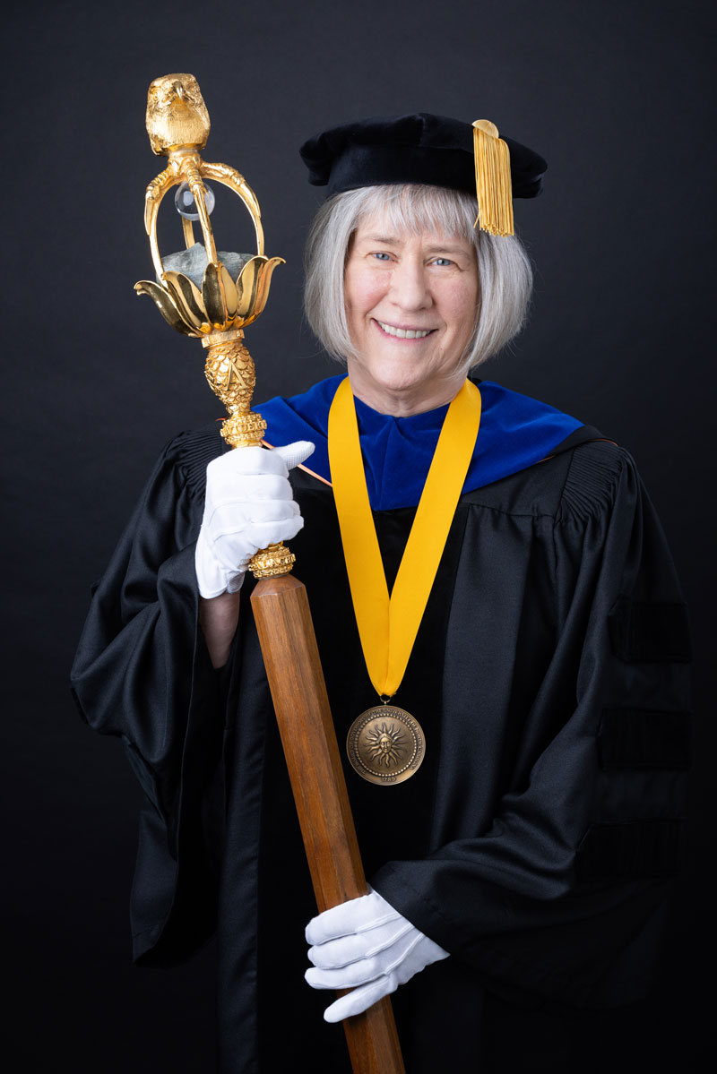 Dr. Cathy McKinney holding the university mace.