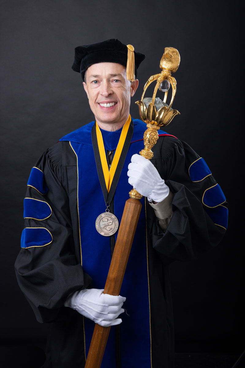 Dr. David Dickinson holding the university mace.