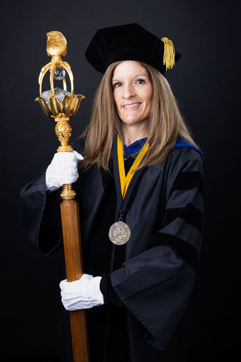Dr. Melissa Gutschall holding the university mace.