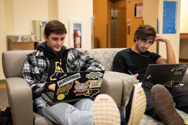 Students lounging with laptops